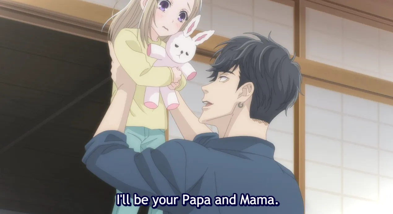 Keiya sosteniendo a un joven Isaku en sus brazos.  El texto del subtítulo dice: ¡Seré tu papá y tu mamá!