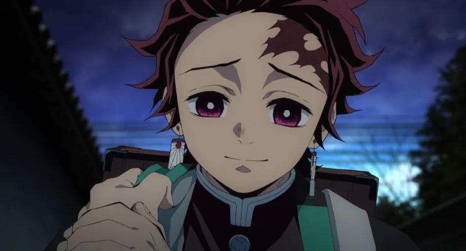 Tanjiro dando una sonrisa triste y empática.